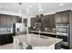 Spacious kitchen with granite island, stainless appliances, and modern pendant lighting at 612 Via Isabelle Dr, Debary, FL 32713