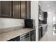 Well-equipped kitchen with stainless steel appliances, granite counters, and dark wood cabinetry at 612 Via Isabelle Dr, Debary, FL 32713