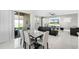 Open-concept living and dining area featuring a modern marble table, leather sofas and sliding glass doors to the backyard at 612 Via Isabelle Dr, Debary, FL 32713