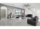Spacious living room with tile floors, a large TV, and elegant decor creating a comfortable and stylish space at 612 Via Isabelle Dr, Debary, FL 32713
