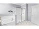 Modern main bathroom showcasing a soaking tub, a shower, and elegant fixtures for a spa-like experience at 612 Via Isabelle Dr, Debary, FL 32713