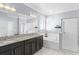 Main bathroom featuring dual sinks, a soaking tub, and a separate shower with neutral colors and sleek design at 612 Via Isabelle Dr, Debary, FL 32713