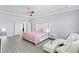 Spacious main bedroom with a seating area, and luxury vinyl plank floors and a doorway to the main bathroom at 612 Via Isabelle Dr, Debary, FL 32713