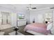 Bright main bedroom with wood-look flooring, a TV, ensuite bathroom, and ample space for a comfortable retreat at 612 Via Isabelle Dr, Debary, FL 32713