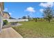 Spacious backyard featuring a patio with outdoor seating and a well-maintained lawn at 638 Ogelthorpe Dr, Davenport, FL 33897