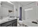 Neat bathroom with a shower-tub combo, toilet, and vanity with a dark cabinet at 638 Ogelthorpe Dr, Davenport, FL 33897