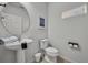 Clean bathroom with a pedestal sink, white toilet, and bright natural light at 638 Ogelthorpe Dr, Davenport, FL 33897