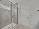 Modern bathroom featuring tiled walk-in shower with glass door and decorative tile accents at 638 Ogelthorpe Dr, Davenport, FL 33897