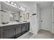Spacious bathroom with double sink vanity, a large mirror, and bright lighting at 638 Ogelthorpe Dr, Davenport, FL 33897