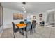 Open dining room features modern light fixture, tile floor, and staircase access at 638 Ogelthorpe Dr, Davenport, FL 33897
