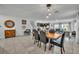 Open concept dining room with neutral tile flooring and modern décor adjacent to the Gathering room at 638 Ogelthorpe Dr, Davenport, FL 33897