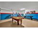 Spacious game room with a pool table, foosball table, and playful decor at 638 Ogelthorpe Dr, Davenport, FL 33897