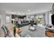 Spacious living room with a large sectional couch, open kitchen, and sliding glass doors to the backyard at 638 Ogelthorpe Dr, Davenport, FL 33897