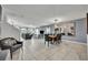 Bright living room featuring tile floors, staircase, modern furniture, and natural light from large windows at 638 Ogelthorpe Dr, Davenport, FL 33897
