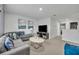 Relaxing living room featuring a comfortable sofa, large TV, and stylish decor at 638 Ogelthorpe Dr, Davenport, FL 33897