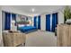 Spacious main bedroom with a queen-size bed, arm chair, bright windows, and plush carpet at 638 Ogelthorpe Dr, Davenport, FL 33897