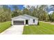Charming single-story home with board and batten siding, complemented by a well-maintained lawn at 7007 Sw 131St Ave, Ocala, FL 34481