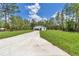 Beautiful one-story home with board and batten siding, green lawn, and a concrete driveway leading to the garage at 7007 Sw 131St Ave, Ocala, FL 34481