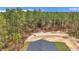 An aerial view of the home showing the roof, driveway, and surrounding trees at 7117 Sw 131St Ave, Ocala, FL 34481