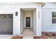 Welcoming entryway featuring modern lighting and a stylish black door at 7117 Sw 131St Ave, Ocala, FL 34481