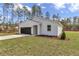 New one-story home with a gray garage door and tidy landscaping at 7117 Sw 131St Ave, Ocala, FL 34481