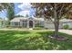 Charming one-story home featuring a well-manicured lawn, mature landscaping, and a welcoming entrance at 7506 Lindenhurst Dr, Orlando, FL 32836
