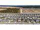 Aerial view showcases a community with houses, green spaces, and nearby construction at 760 Annabell Ridge Rd, Minneola, FL 34715