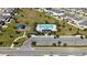 Aerial view of a community pool and play area, surrounded by lush landscaping and a parking lot at 760 Annabell Ridge Rd, Minneola, FL 34715