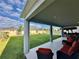 A spacious backyard features a covered patio, lush lawn, and a charming outdoor seating area, perfect for entertaining at 760 Annabell Ridge Rd, Minneola, FL 34715