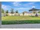 Spacious backyard with lush green grass, play structure, and white fence at 760 Annabell Ridge Rd, Minneola, FL 34715