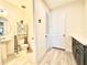 Bathroom featuring a pedestal sink, toilet, storage cabinet, and access to additional spaces at 760 Annabell Ridge Rd, Minneola, FL 34715