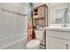 Bathroom featuring a shower-tub combination, decorative shelving over the toilet, and a sink vanity at 760 Annabell Ridge Rd, Minneola, FL 34715