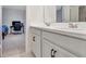Bathroom featuring a double sink vanity with white cabinetry and a view into an organized bedroom at 760 Annabell Ridge Rd, Minneola, FL 34715
