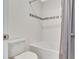 Bright bathroom featuring a shower-tub combo with white tile and a decorative accent strip at 760 Annabell Ridge Rd, Minneola, FL 34715