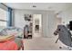 Comfortable bedroom featuring a lounging chair, workspace, and adjacent closet for storage at 760 Annabell Ridge Rd, Minneola, FL 34715