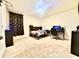 A cozy bedroom setup featuring a comfortable bed and gaming station at 760 Annabell Ridge Rd, Minneola, FL 34715