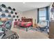 Well-organized bedroom featuring geometric wall design, furniture, desk, and window at 760 Annabell Ridge Rd, Minneola, FL 34715