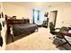 Cozy bedroom with neutral carpet, a bed, desk, and chair, perfect for relaxing at 760 Annabell Ridge Rd, Minneola, FL 34715