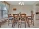 Inviting dining room with a wooden table, upholstered chairs, and a bright window with sheer curtains at 760 Annabell Ridge Rd, Minneola, FL 34715