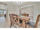 Well-lit dining area with a wooden table, comfortable seating, and views into the adjacent rooms at 760 Annabell Ridge Rd, Minneola, FL 34715