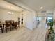 Spacious dining room with wood table set and chandelier, seamlessly connecting to the kitchen and living area at 760 Annabell Ridge Rd, Minneola, FL 34715