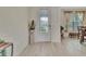 Bright entryway featuring a decorative glass door, neutral walls, and stylish light wood-look tile flooring at 760 Annabell Ridge Rd, Minneola, FL 34715