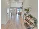 Welcoming entryway with light wood flooring, a decorative console table, and a glimpse of the living area at 760 Annabell Ridge Rd, Minneola, FL 34715
