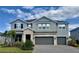 Charming two-story home with a three-car garage and stone accents at 760 Annabell Ridge Rd, Minneola, FL 34715