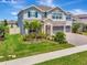 Charming two-story home with a well-kept lawn, landscaped garden, and convenient three-car garage at 760 Annabell Ridge Rd, Minneola, FL 34715