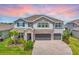 Beautiful two-story home with a three-car garage, stone accents, and well-manicured landscaping at 760 Annabell Ridge Rd, Minneola, FL 34715