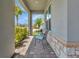 Inviting front porch with stylish chairs, stone accents and brick paving offers a cozy outdoor space at 760 Annabell Ridge Rd, Minneola, FL 34715