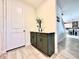 Hallway with wood-look tile flooring, olive cabinet and a door leading to the main living area at 760 Annabell Ridge Rd, Minneola, FL 34715