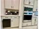 Close-up of kitchen, featuring built-in stainless steel oven and microwave along with granite countertop at 760 Annabell Ridge Rd, Minneola, FL 34715