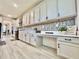 Modern kitchen featuring sleek countertops, cabinetry, and a built-in desk area at 760 Annabell Ridge Rd, Minneola, FL 34715